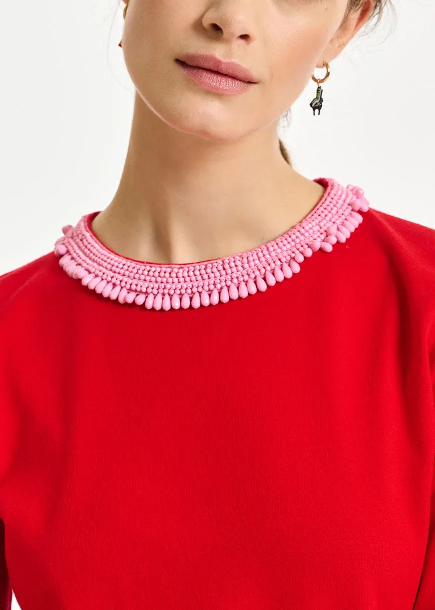 Red fine-knit sweater with bead-embroidered neckline