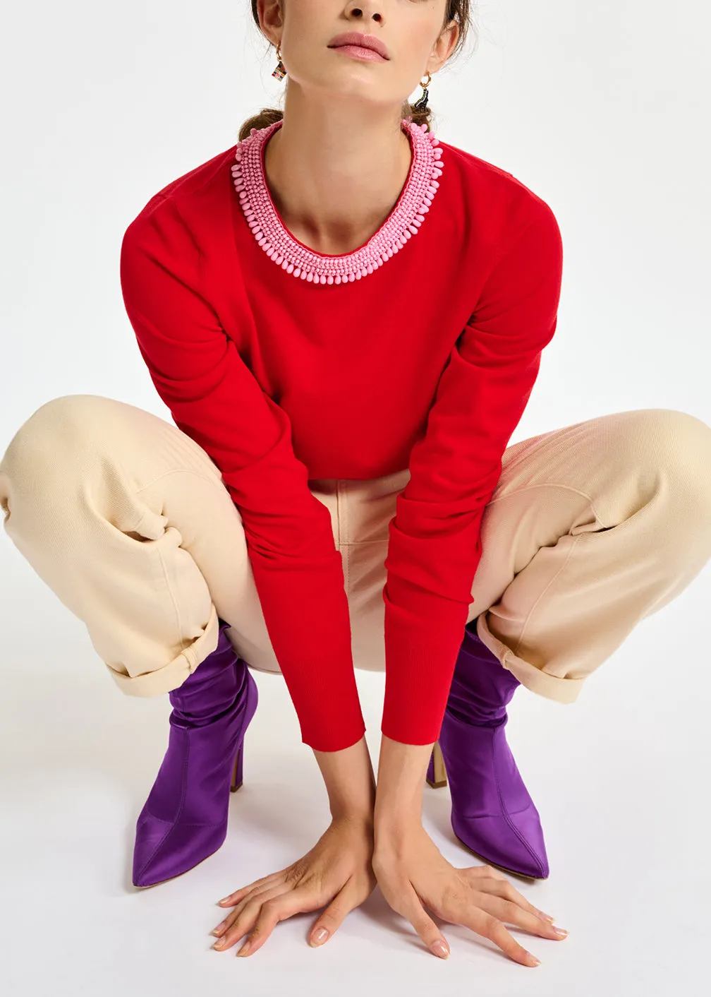 Red fine-knit sweater with bead-embroidered neckline